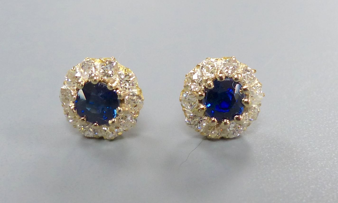 A pair yellow metal, sapphire and diamond circular cluster earstuds (no butterflies), diameter 8mm, gross 1.6 grams.